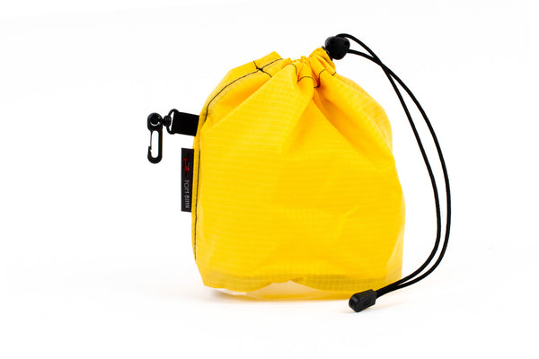 A Medium, clear-bottom Yarn Stuff Sack in Marigold (yellow with light yellow grid) 210 Cerylon.